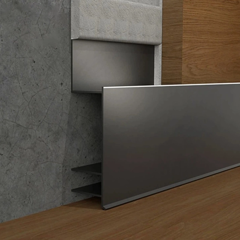 Grey aluminum shadow gap skirting for recessed wall finish.